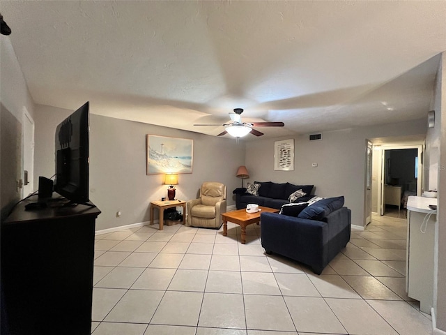 living room featuring ceiling fan and light tile patterned floors