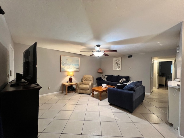3124 US Highway 441 SE Unit I-4, Okeechobee, FL 34974 - living room featuring light tile patterned floors, a ceiling fan, and baseboards