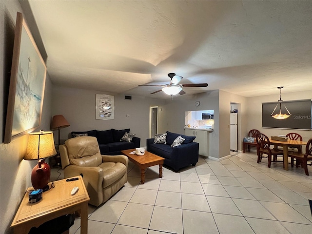 tiled living room with ceiling fan