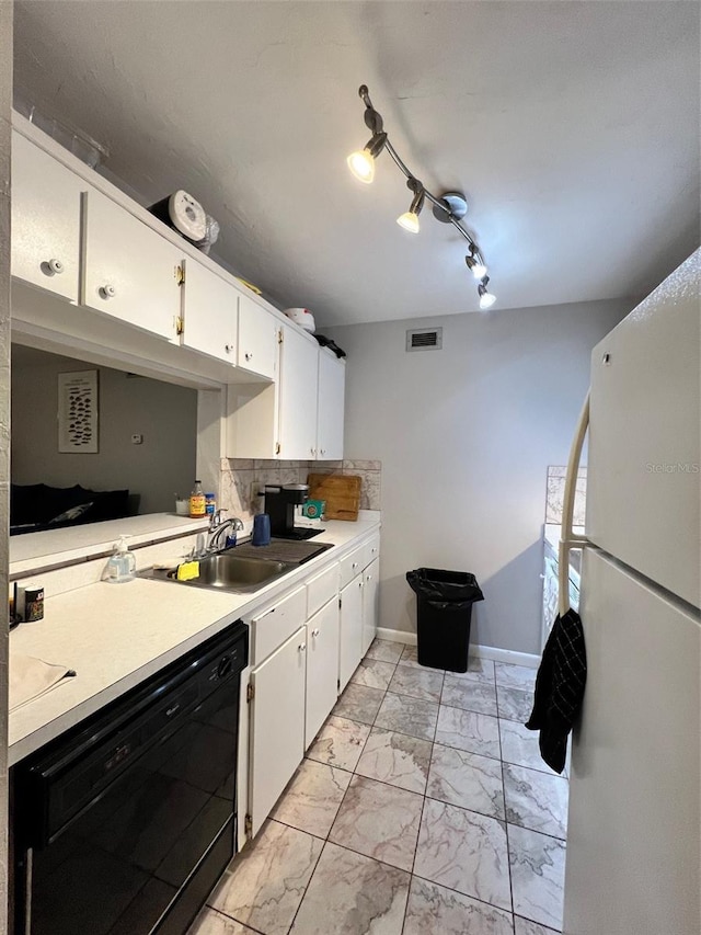 kitchen featuring dishwasher, sink, white cabinetry, white fridge, and track lighting