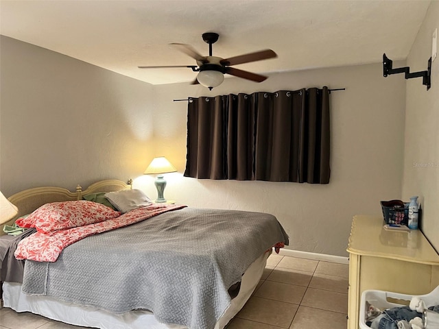 bedroom featuring light tile patterned floors and ceiling fan