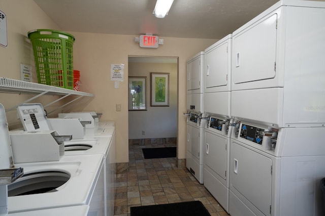 clothes washing area with stacked washer and clothes dryer and washer and clothes dryer