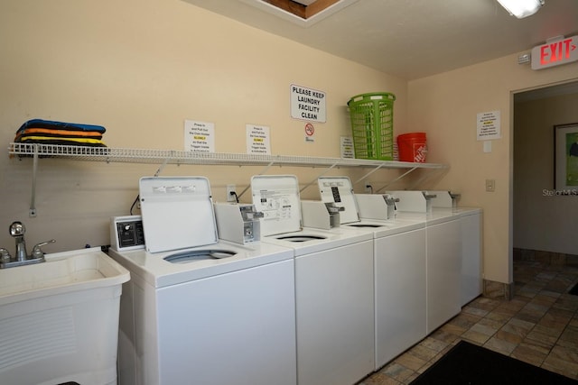 washroom featuring washing machine and dryer and sink