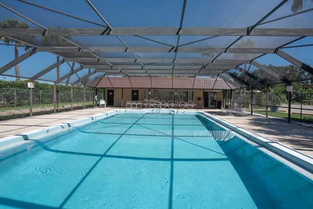 view of swimming pool with a patio and glass enclosure