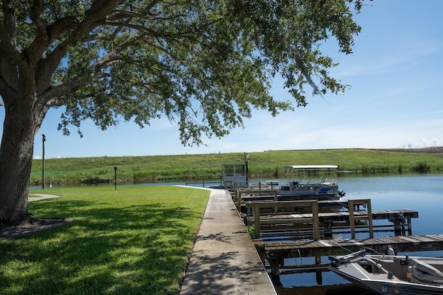 dock area featuring a yard, a water view, and a rural view