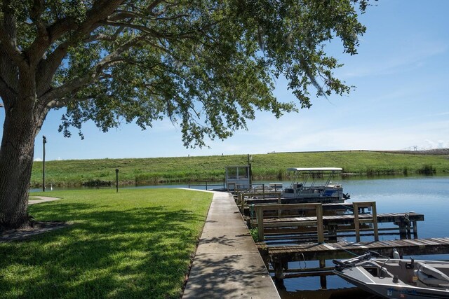 3124 US Highway 441 SE Unit I-4, Okeechobee, FL 34974 - dock featuring a water view and a lawn