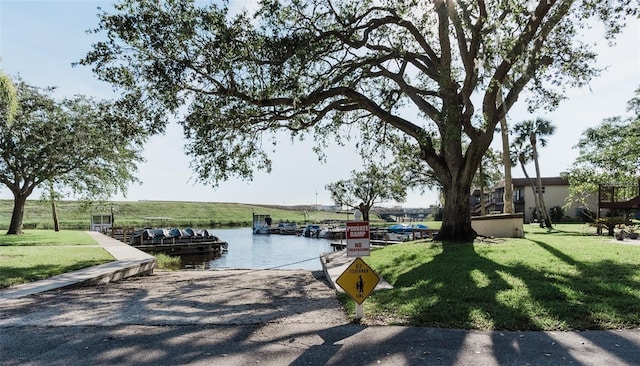 3124 US Highway 441 SE Unit I-4, Okeechobee, FL 34974 - view of community featuring a boat ramp, a water view, a yard, and a dock