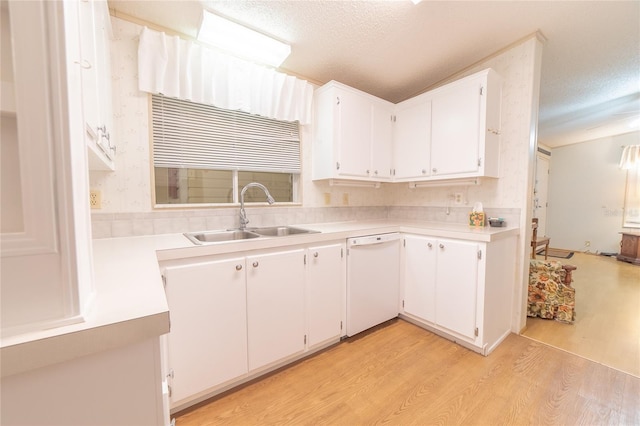 kitchen with dishwasher, sink, a textured ceiling, light hardwood / wood-style floors, and white cabinetry