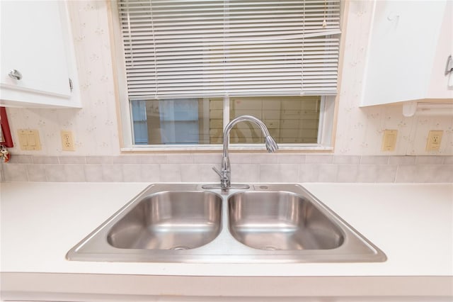 room details featuring white cabinetry and sink