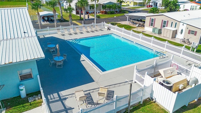 view of pool featuring central AC unit and a patio