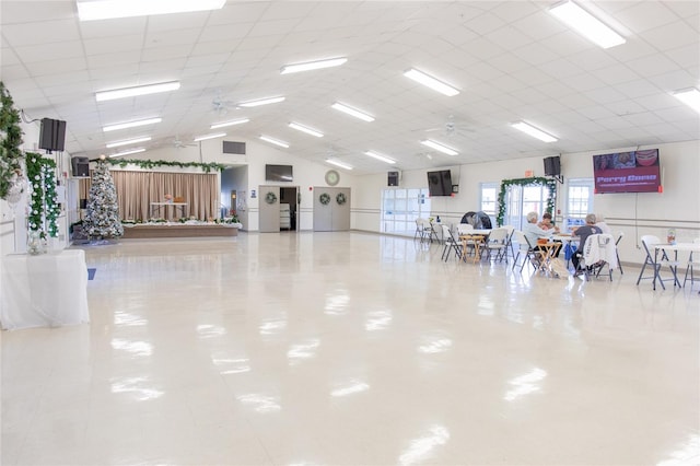 miscellaneous room featuring tile patterned flooring, vaulted ceiling, and ceiling fan