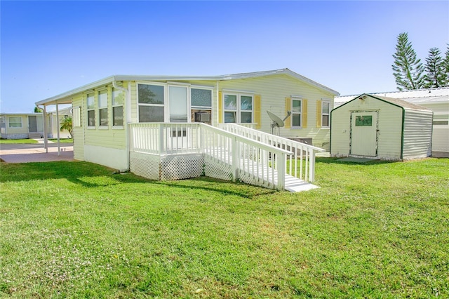 back of house with a yard and a storage unit