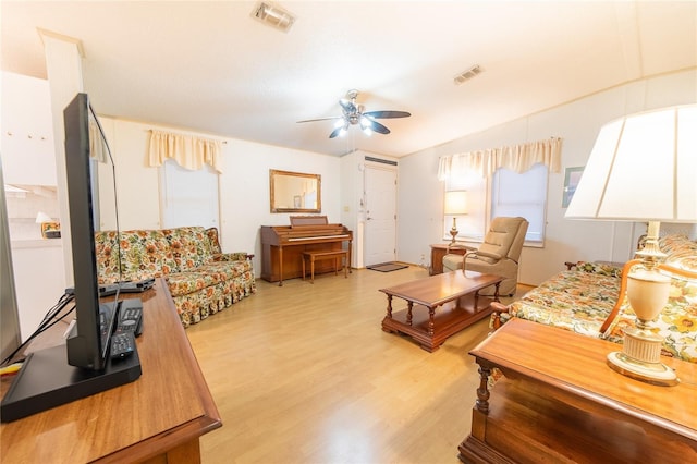 living room with ceiling fan and light hardwood / wood-style floors