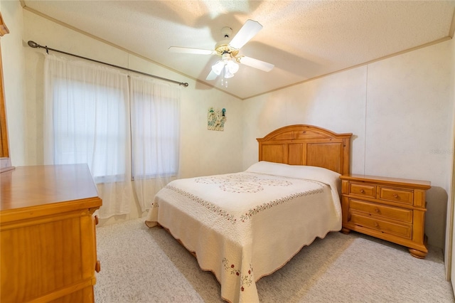 bedroom with ceiling fan, a textured ceiling, and light carpet