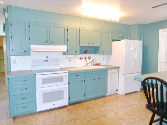 kitchen featuring decorative backsplash, sink, and white appliances