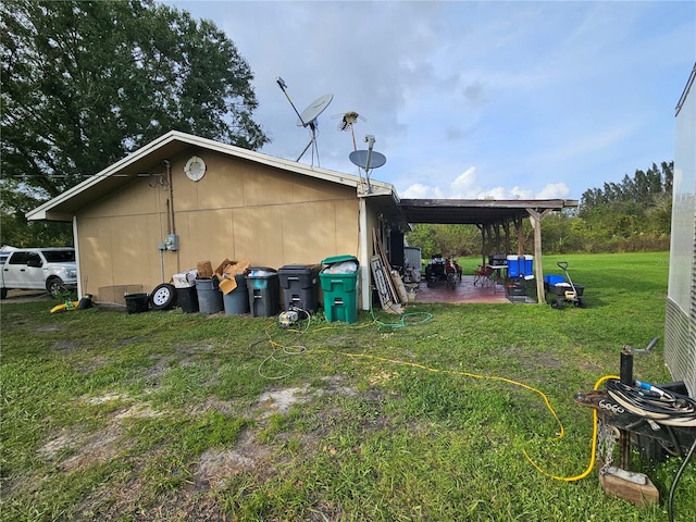 view of side of property with a lawn and a patio