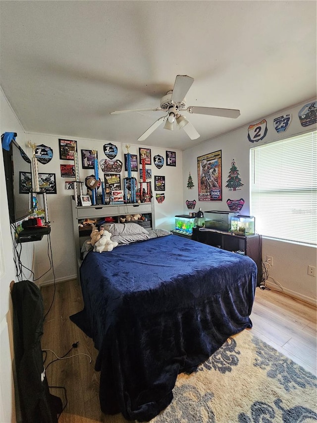 bedroom with wood-type flooring and ceiling fan