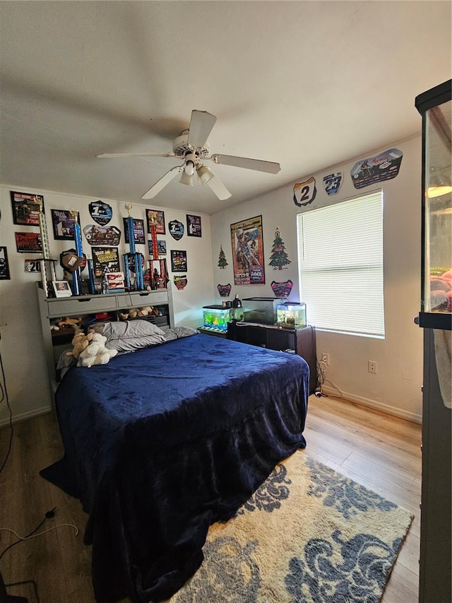 bedroom with ceiling fan and light wood-type flooring