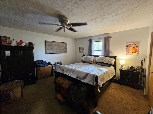 bedroom featuring a textured ceiling, dark colored carpet, and ceiling fan