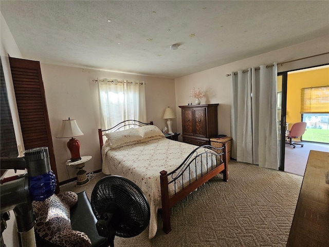 bedroom with a textured ceiling and light colored carpet