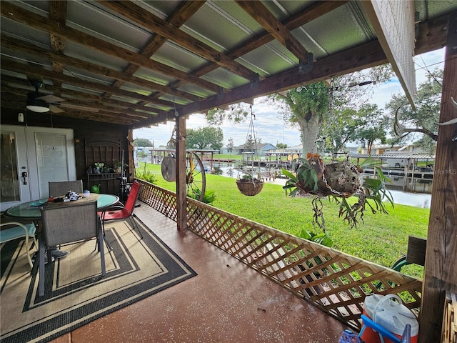 view of patio featuring ceiling fan and a water view