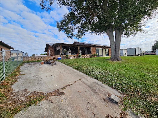 rear view of house featuring a yard