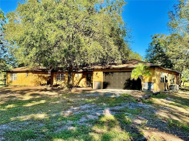 exterior space with a garage and a lawn