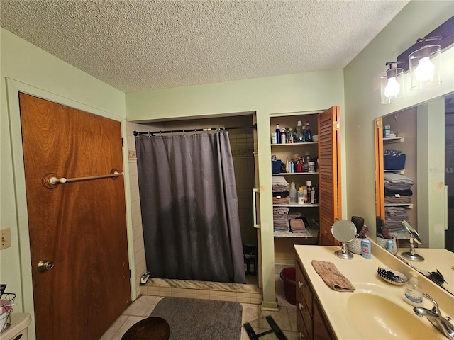 bathroom featuring tile patterned floors, vanity, a textured ceiling, and a shower with shower curtain