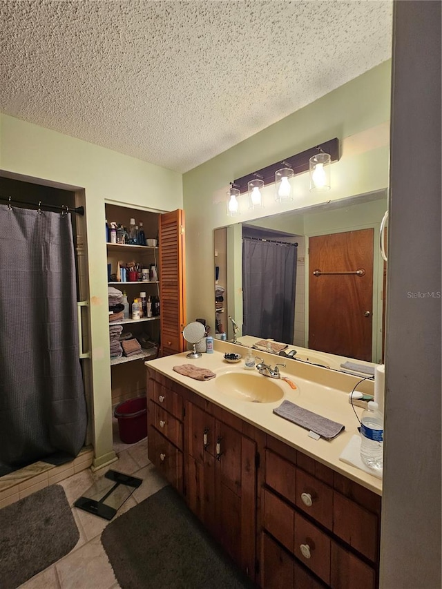 bathroom with tile patterned flooring, vanity, a textured ceiling, and a shower with shower curtain