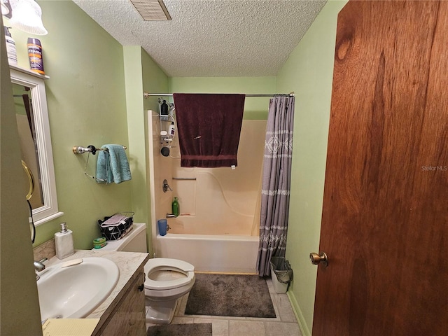 full bathroom featuring vanity, a textured ceiling, shower / tub combo with curtain, and toilet