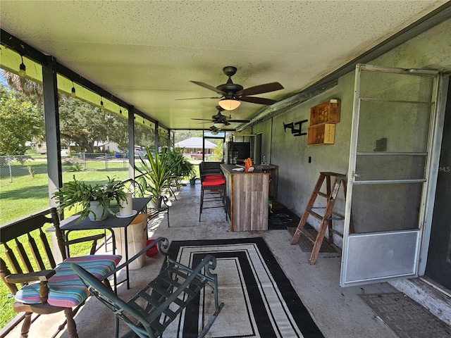 sunroom with ceiling fan and a healthy amount of sunlight