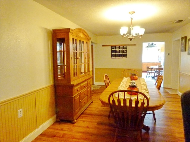 dining room featuring a notable chandelier and wood-type flooring