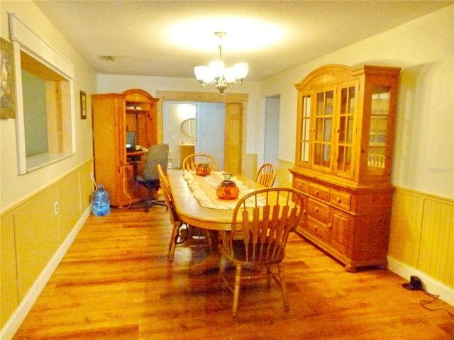 dining room with a chandelier and hardwood / wood-style flooring