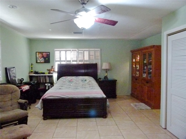 tiled bedroom featuring ceiling fan