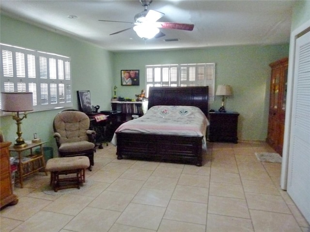 bedroom with ceiling fan and light tile patterned floors