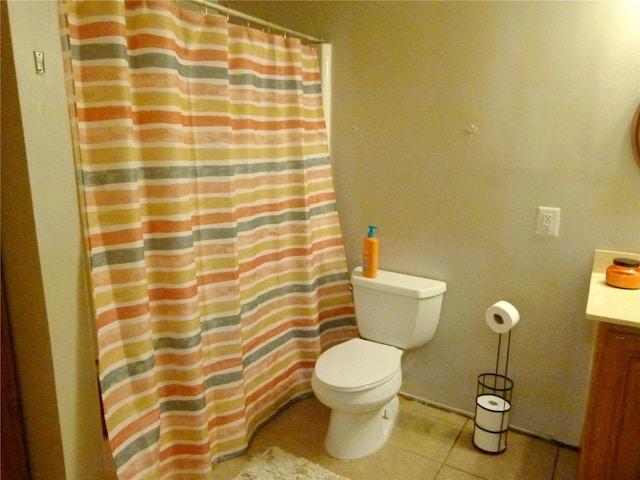 bathroom with tile patterned flooring, vanity, and toilet