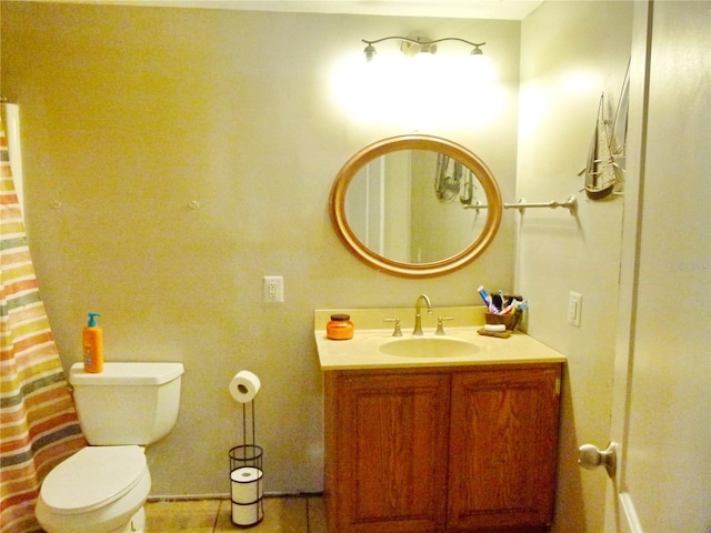 bathroom with tile patterned flooring, vanity, and toilet