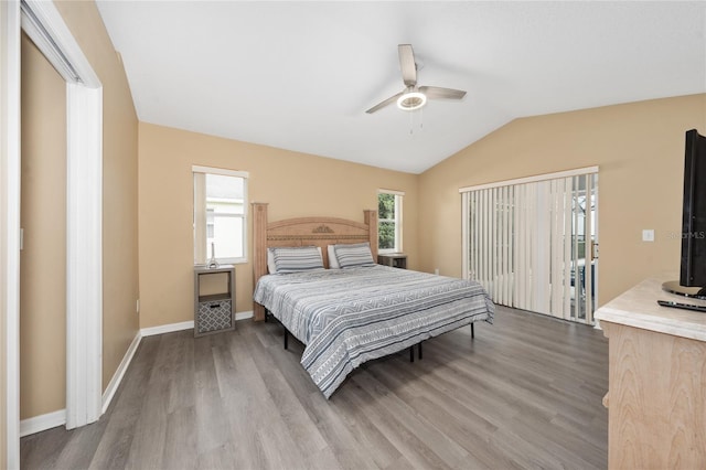 bedroom with hardwood / wood-style floors, vaulted ceiling, and ceiling fan