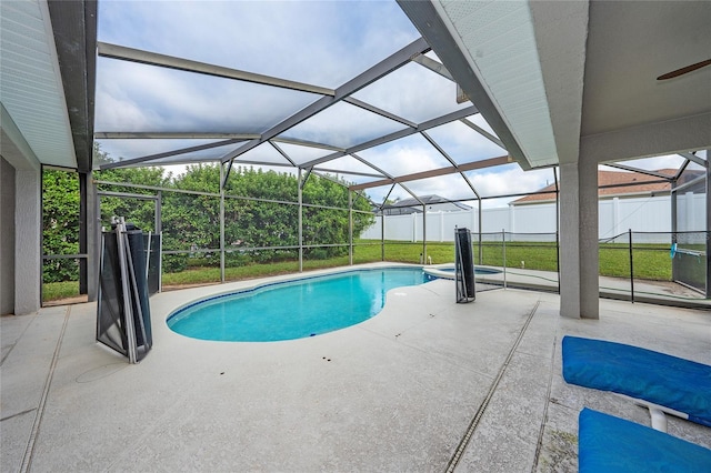 view of swimming pool with a patio, glass enclosure, and a lawn