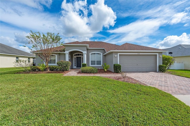 view of front of property with a front yard and a garage