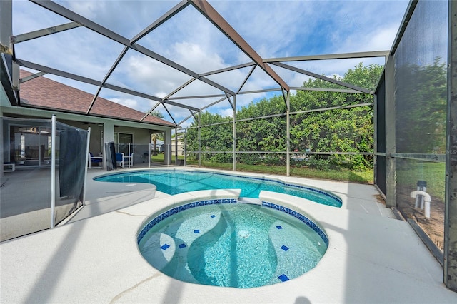 view of swimming pool with an in ground hot tub, a lanai, and a patio area