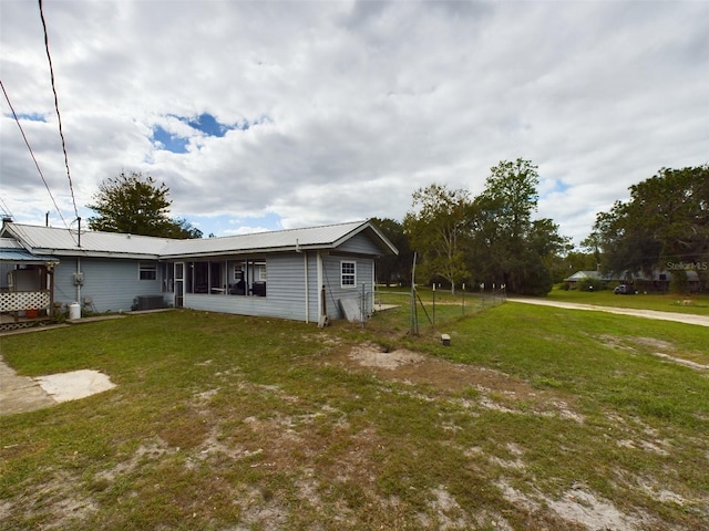 rear view of property featuring a yard