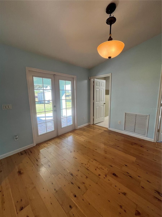 interior space with french doors and light hardwood / wood-style flooring