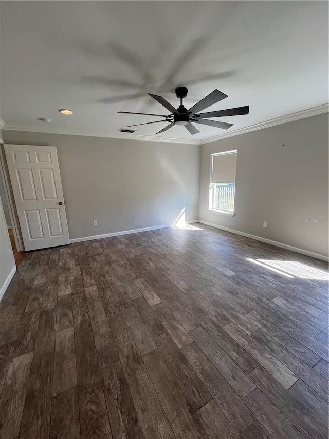 empty room featuring dark hardwood / wood-style flooring, ceiling fan, and ornamental molding