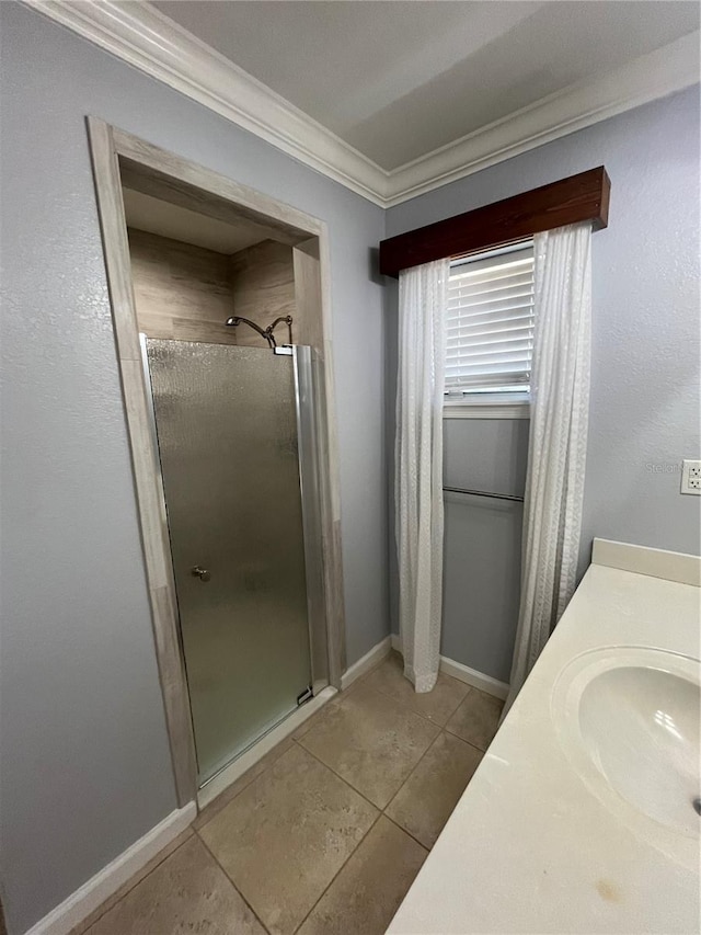 bathroom featuring tile patterned floors, vanity, an enclosed shower, and crown molding