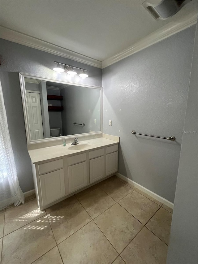 bathroom featuring tile patterned floors, vanity, toilet, and ornamental molding