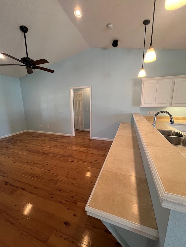 kitchen featuring sink, ceiling fan, decorative light fixtures, dark hardwood / wood-style flooring, and white cabinetry