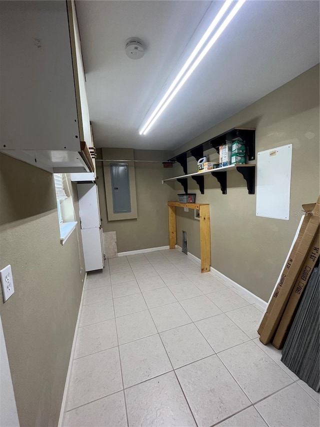 basement featuring electric panel and light tile patterned floors