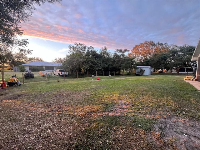 yard at dusk with a storage unit