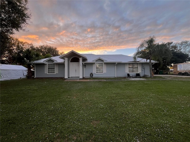 ranch-style house featuring a yard